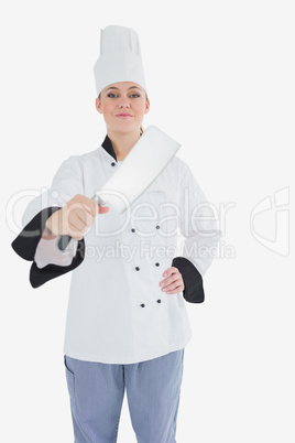 Portrait of female chef with meat cleaver