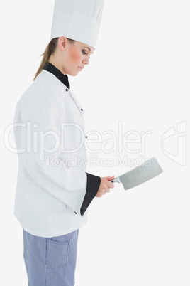 Side view of chef holding meat cleaver