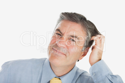 Portrait of businessman scratching head