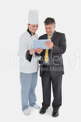 Businessman and chef using digital tablet