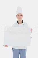 Portrait of chef holding billboard