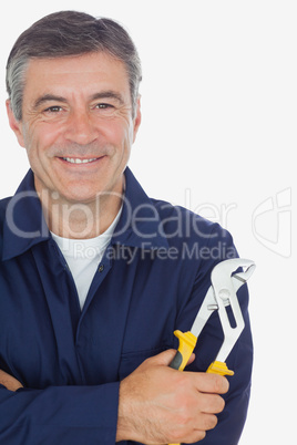 Mechanic with arms crossed holding  pliers