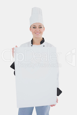 Female chef with blank billboard