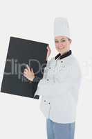 Female chef with black billboard