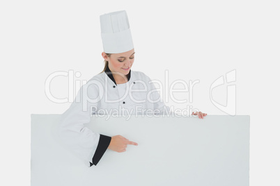 Female chef pointing on billboard