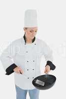 Chef holding frying pan and spatula