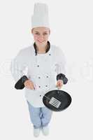 Female chef with spatula and frying pan