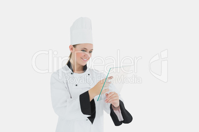 Female chef using glass tablet