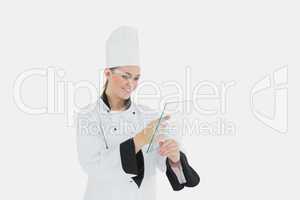 Female chef using glass tablet