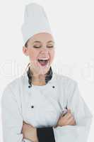 Chef holding wire whisk as she laughs