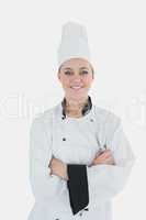 Confident female chef holding wire whisk