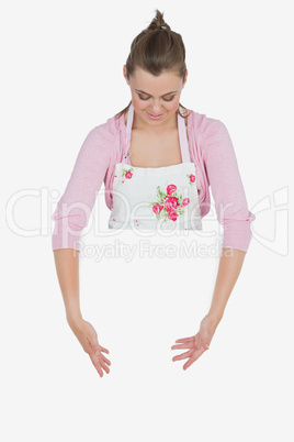 Woman in apron showing blank billboard
