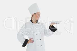 Female chef looking at plate