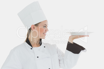 Female chef looking at an empty plate