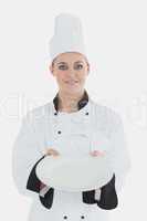 Female chef showing an empty plate