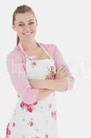 Woman in apron standing with arms crossed