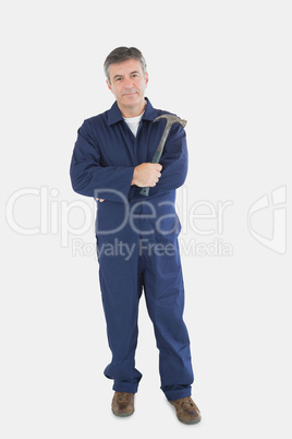 Confident mechanic holding hammer