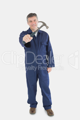 Portrait of technician holding hammer