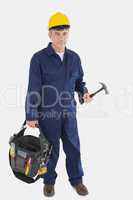 Mature mechanic carrying tool bag