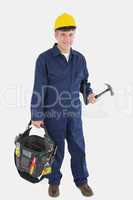 Technician wearing hardhat while carrying tool bag