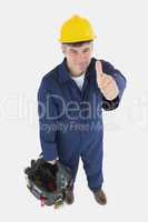 Technician with tool bag gesturing thumbs up