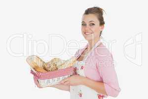 Young woman holding basket full of breads
