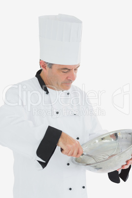 Chef using whisk and mixing bowl