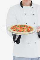 Male chef offering pizza