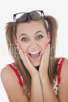 Surprised young woman with hands on face