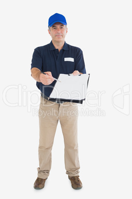 Mature delivery man holding out clipboard Mature delivery man holding out clipboard