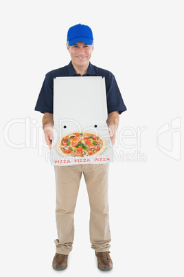 Cheerful delivery man holding pizza