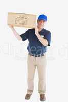 Mature courier man carrying cardboard box