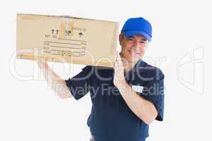 Happy delivery man carrying package