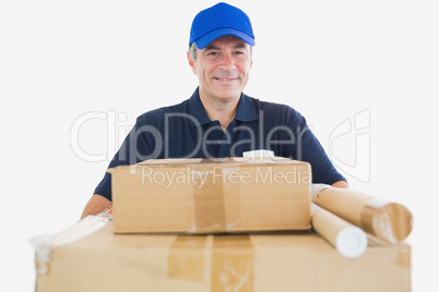 Happy mature courier man carrying cardboard boxes