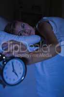 Blonde woman stopping her alarm clock