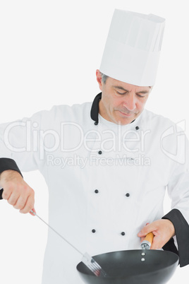 Chef using spatula and frying pan