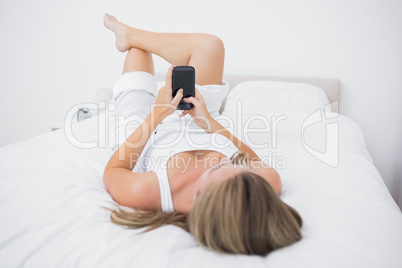 Calm woman touching her phone