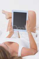 Calm woman touching her tablet pc