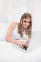 Smiling woman typing on the laptop