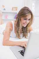 Cheerful woman typing on the laptop