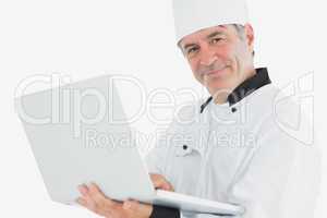 Male chef using laptop smiling