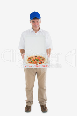 Portrait of happy delivery man holding pizza