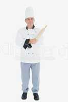 Portrait of male chef holding rolling pin