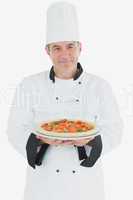 Portrait of chef with pizza