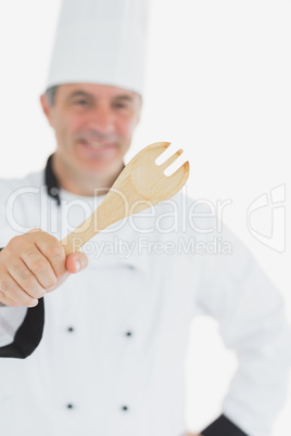 Happy chef holding out spatula