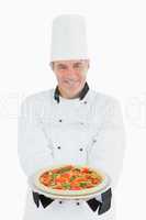 Happy chef offering pizza