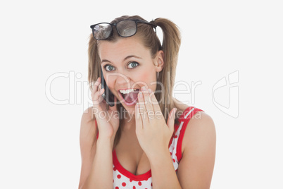 Amazed young woman using cell phone