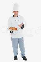 Happy male chef displaying pizza