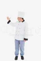 Confident chef showing something on white