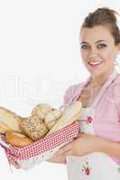 Happy young maid holding bread basket